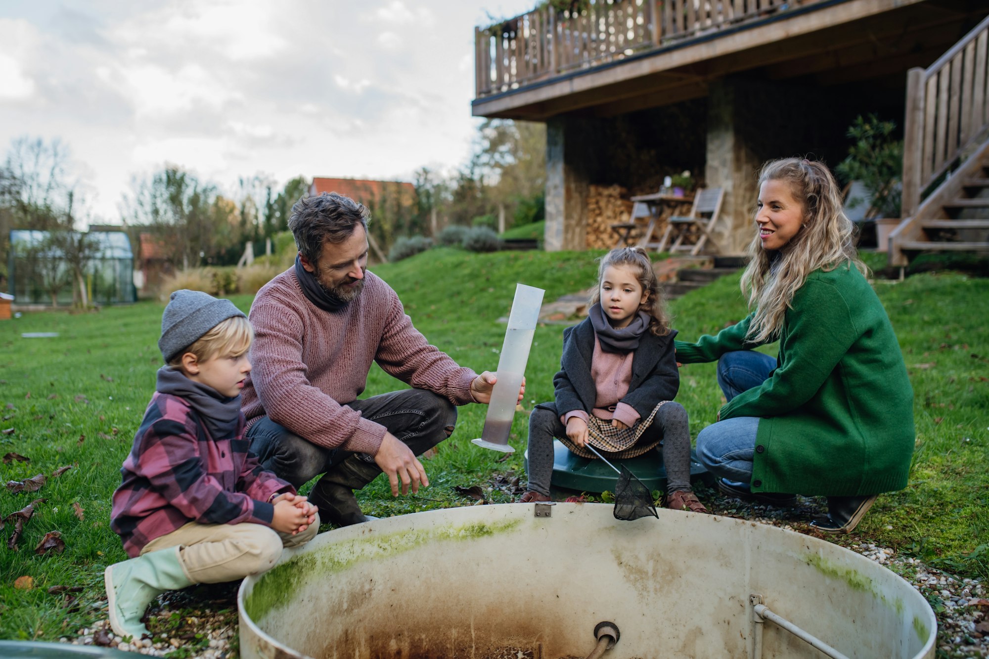 The family checking the water quality in the home wastewater treatment system. Concept of